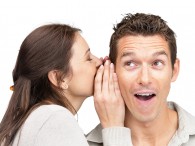 Woman whispering in a man's ear